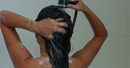 Woman washing hair in showerの写真素材