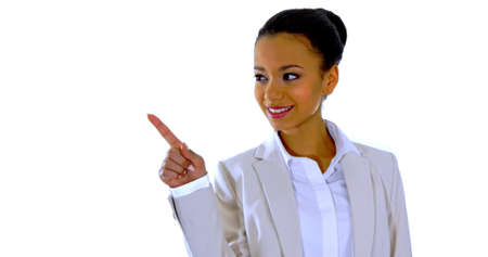 Cute young woman points a finger awayの写真素材