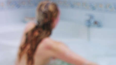 Unrecognizable woman washing hairの写真素材