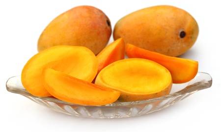 Fresh sliced Mangoes with whole onesの写真素材