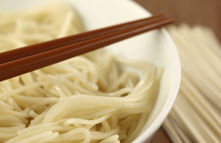 Noodles- cooked and uncooked with chopstickの写真素材