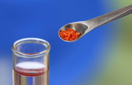 Test tube with spatula containing chemicalの写真素材
