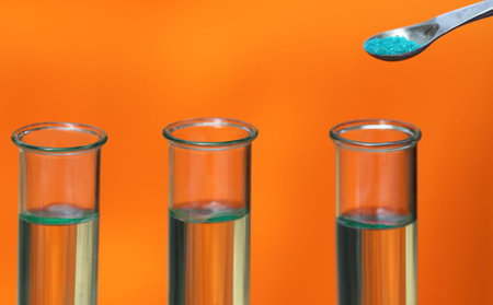 Test tubes with spatula containing chemical in a laboratory