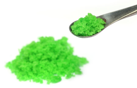 Green Chemical on steel spatula over white backgroundの写真素材