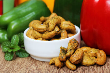 Cashew nuts with green mint leaves and capsicumの写真素材