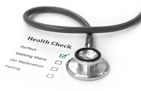 Health checklist and a stethoscope on a paperの写真素材