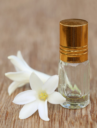 Tuberose or Rajnigandha of Southeast Asia with herbal extract on wooden surfaceの写真素材
