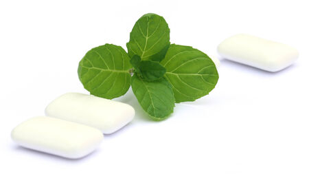Chewing gum with mint leaves over white  backgroundの写真素材