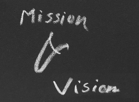 Mission & vision written in blackboard by white chalkの写真素材