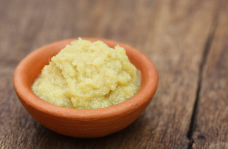 Fresh crushed ginger in a bowlの写真素材