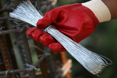 Construction wire holding by handの写真素材