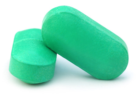 Two green tablets over white backgroundの写真素材