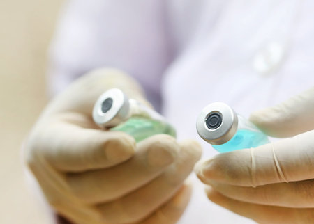 Close up of two vials holding by a doctor