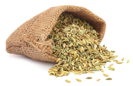 Fennel seeds in a sack over white backgroundの写真素材