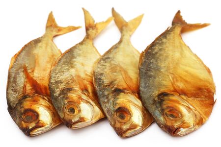 Dry scaled sardine fish over white backgroundの写真素材