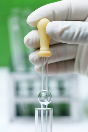 Dropper holding by hand in laboratoryの写真素材