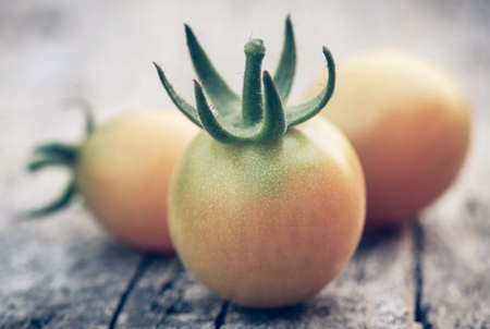Fresh organic tomatoes on wooden surfaceの写真素材