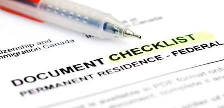 Document checklist for Visa application Canada with a ballpoint