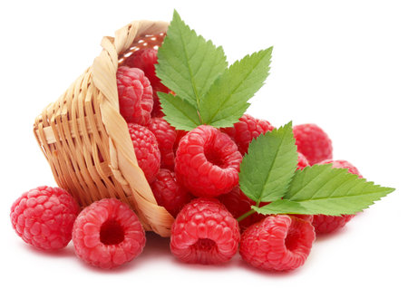 Fresh Raspberry in a basket over white background