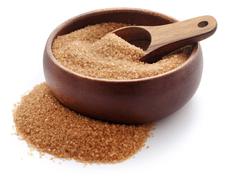 Brown sugar with wooden scoop and bowl over white backgroundの写真素材