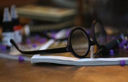 Old spectacle on a wooden table as working concept