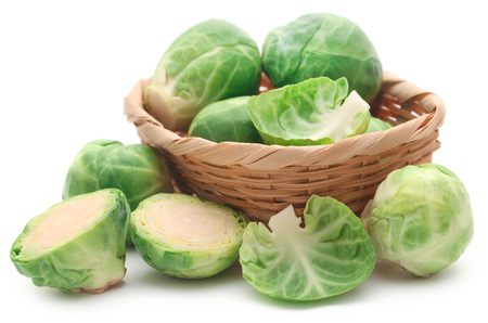 Brussels Sprouts in a basket isolated over white backgroundの写真素材