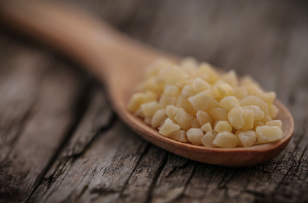 Small pieces of chopped almond in wooden scoopの写真素材