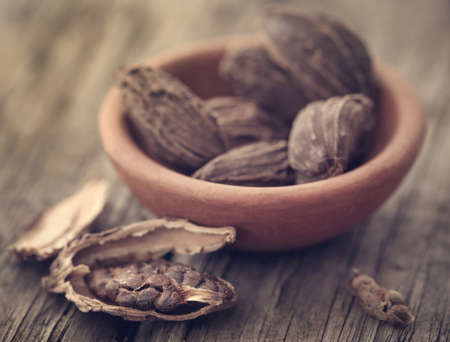 Black cardamom on wooden surfaceの写真素材