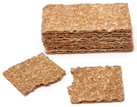 Crispbread with sesame seeds over white background