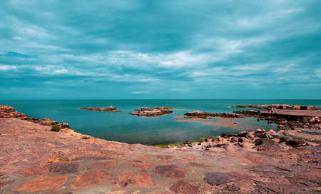 Colorful rock formation in the sea around picturesque small town Gudhjem in Bornholm, Denmarkの写真素材