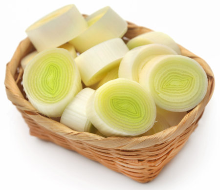 Fresh leek stem chopped in a basket over white background