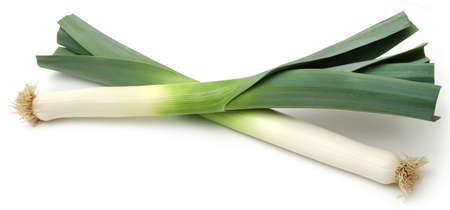 Fresh leek stems and leaves over white backgroundの写真素材