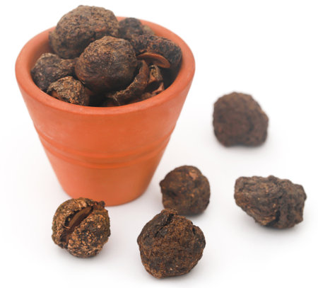 Dried amla fruits in bowl over white backgroundの写真素材