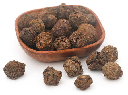Dried amla fruits in bowl over white backgroundの写真素材