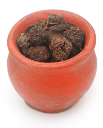 Dried amla fruits in bowl over white backgroundの写真素材