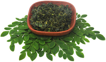 Moringa leaves fresh and crushed in a bowlの写真素材