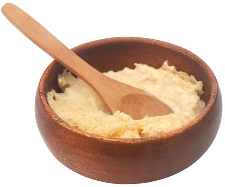Fresh yogurt in a bowl with wooden spoonの写真素材