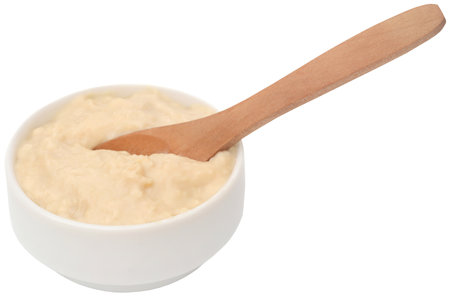 Fresh yogurt in a bowl with wooden spoonの写真素材