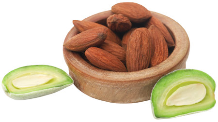 Green almond with peeled matured ones in a bowlの写真素材