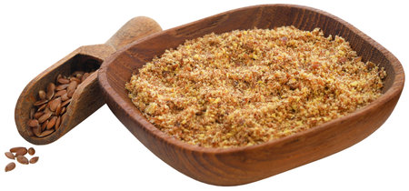 Crushed flax seeds in a bowl with wooden scoopの写真素材