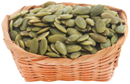Peeled organic pumpkin seeds in a basketの写真素材