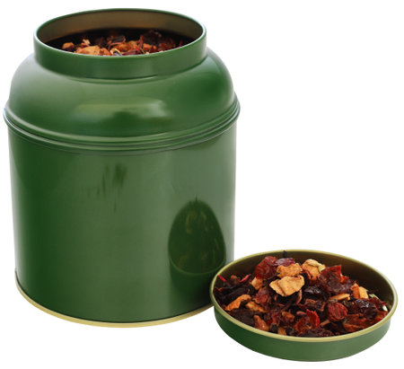 Herbal tea of roselle, rose hips and apple with green containerの写真素材