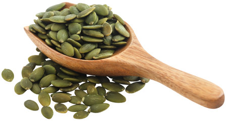 Peeled organic pumpkin seeds in a wooden spoonの写真素材