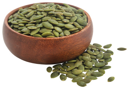 Peeled organic pumpkin seeds in a bowlの写真素材