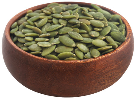 Peeled organic pumpkin seeds in bowlの写真素材