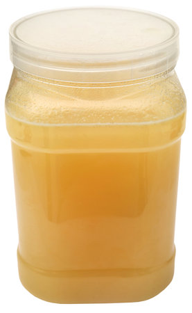 Freshly harvested honey in a jarの写真素材