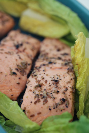 Trout fish pieces cooked with oil black pepper and other ingredientの写真素材