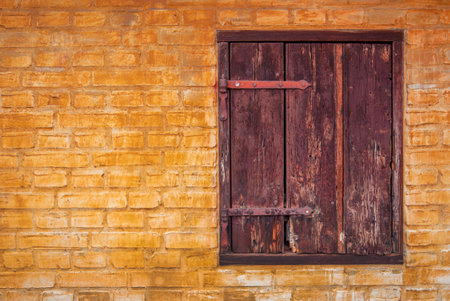 Old window with copy space of yellow brick wallの写真素材