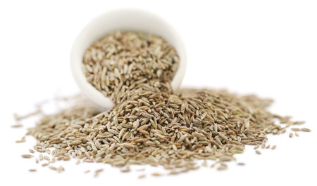 Cumin whole in a bowl over white backgroundの写真素材