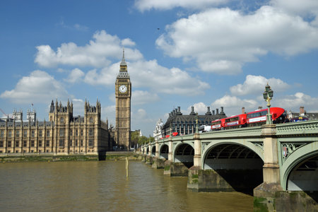 Big Ben with red bus on bridge